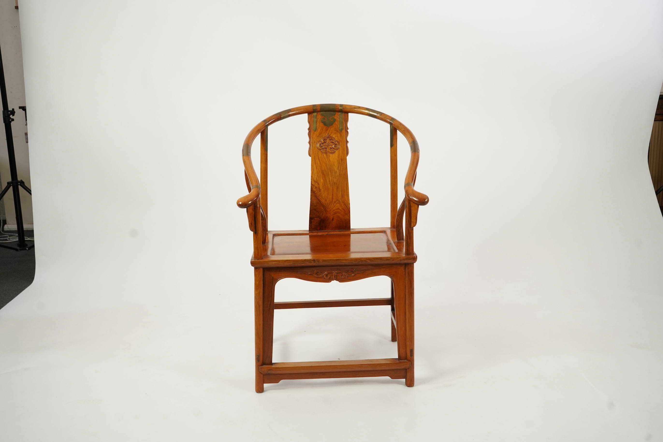 A Chinese huanghuali and brass mounted horseshoe-back armchair, quanyi, late 19th century